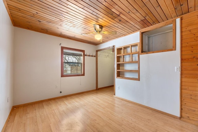 unfurnished room with light wood-type flooring, wooden ceiling, ceiling fan, and baseboards