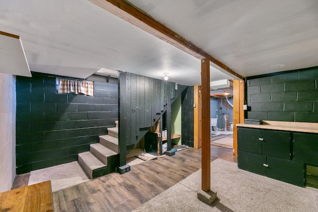 finished basement with stairway and light wood-style floors