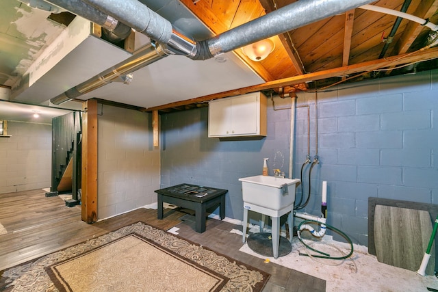 finished basement with stairs and wood finished floors