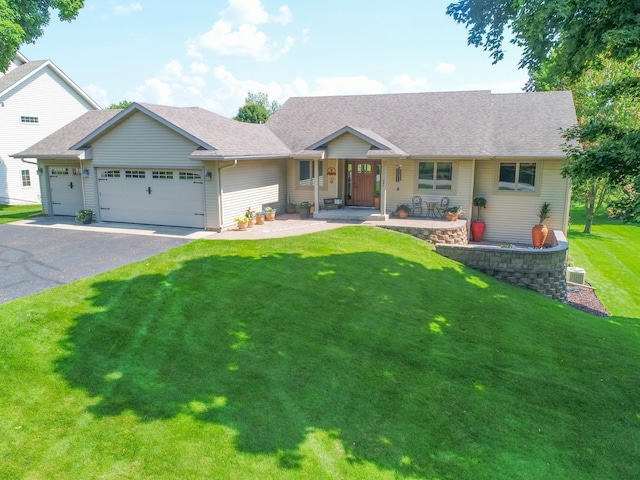 ranch-style home with a garage, a porch, and a front yard