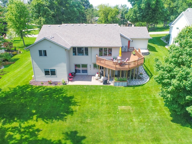 back of house with a wooden deck, a yard, and a patio area