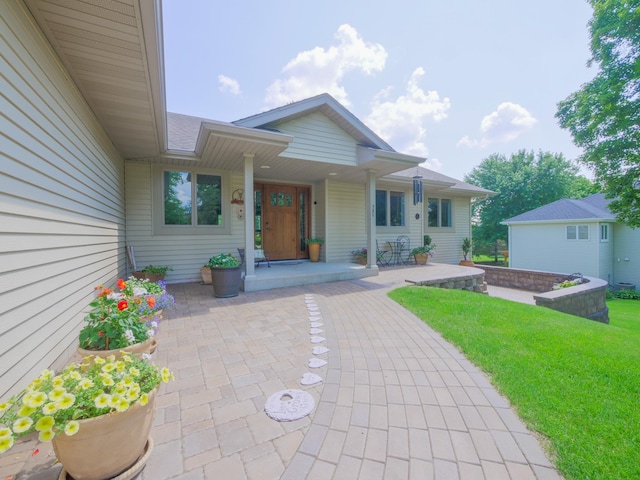 doorway to property with a yard