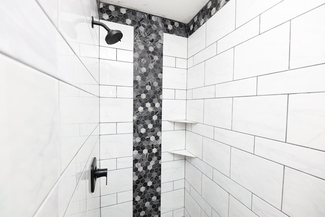 bathroom with tiled shower