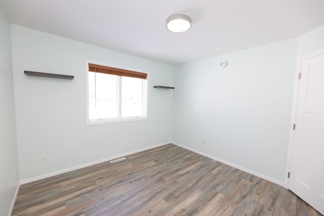 empty room with dark wood-type flooring