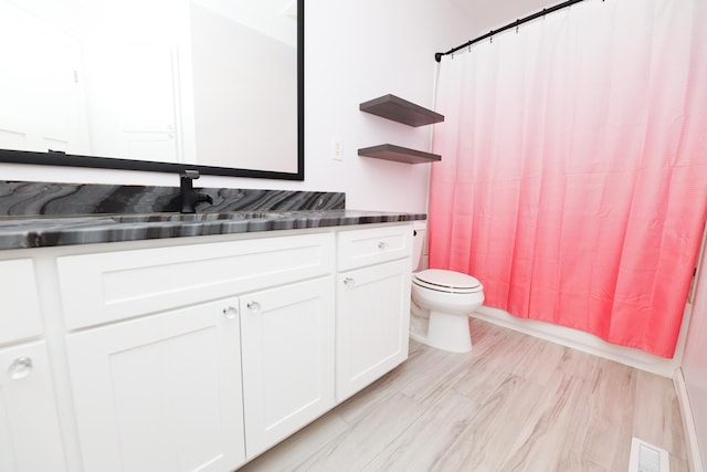 full bathroom with vanity, wood-type flooring, toilet, and shower / bath combo with shower curtain