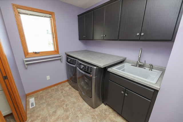 laundry area with sink, cabinets, and washing machine and clothes dryer