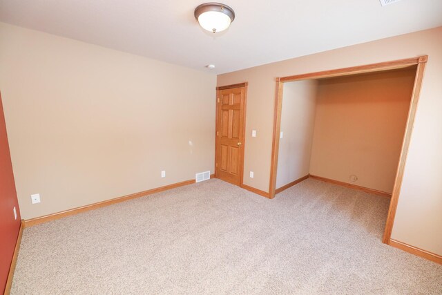 unfurnished bedroom featuring light colored carpet