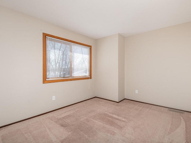 empty room with light colored carpet