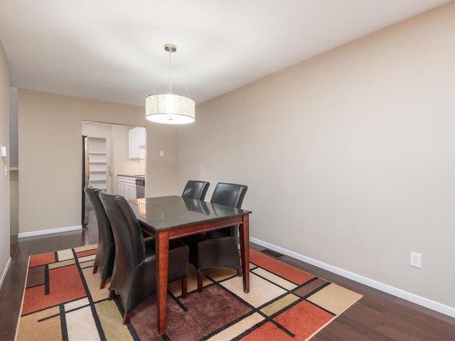 dining area with dark wood-type flooring