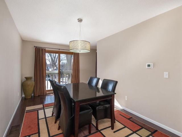 dining space with dark hardwood / wood-style flooring