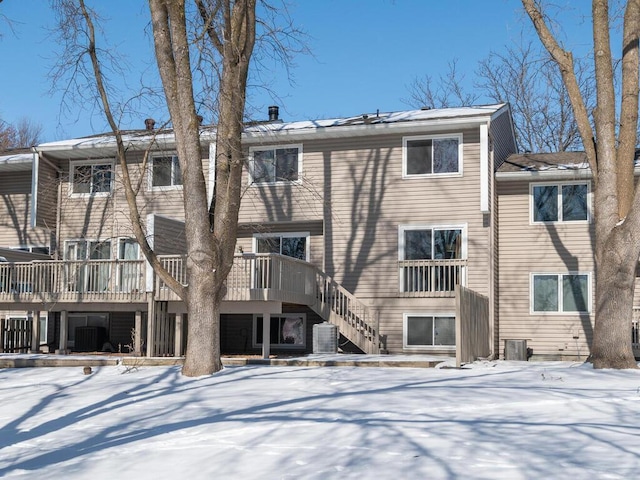 snow covered property featuring a deck and central air condition unit