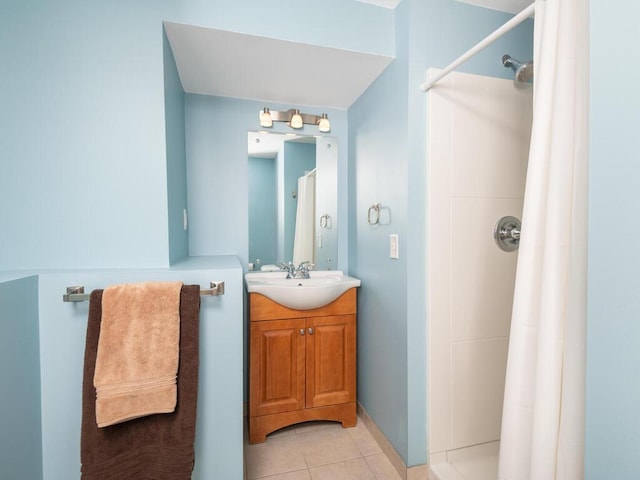 bathroom with vanity, curtained shower, and tile patterned floors