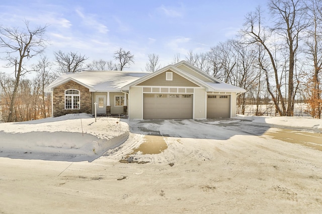 view of front of house featuring a garage and stone siding