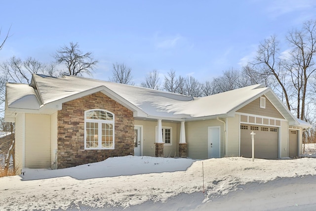 view of front of property featuring an attached garage and stone siding