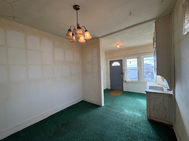 interior space with baseboards, carpet flooring, a sink, and an inviting chandelier