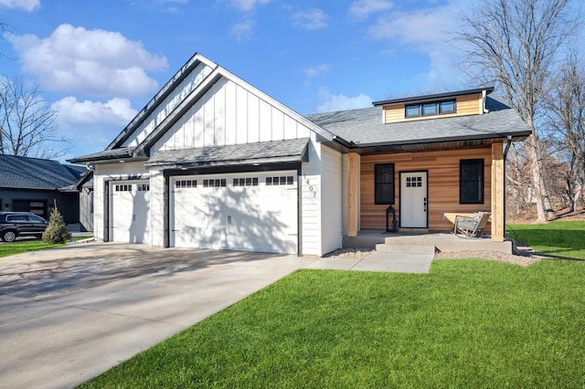 view of front of property with a garage, covered porch, and a front yard