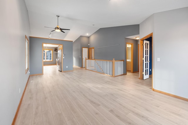 spare room featuring ceiling fan, vaulted ceiling, and light hardwood / wood-style flooring