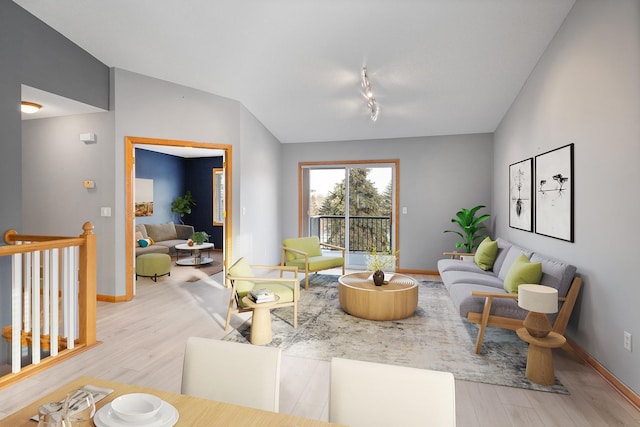 living room featuring light hardwood / wood-style flooring and vaulted ceiling