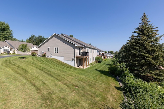 rear view of property featuring a lawn