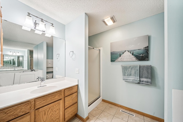 bathroom featuring vanity, an enclosed shower, tile patterned flooring, and a textured ceiling