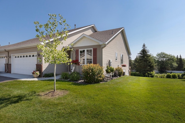 view of front of home with a garage and a front lawn