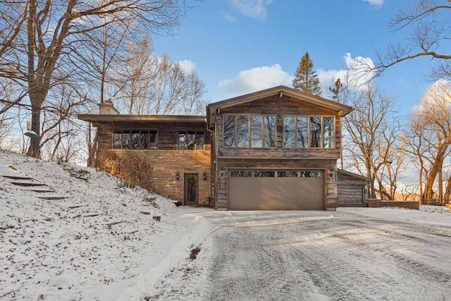 rustic home with a garage and a chimney