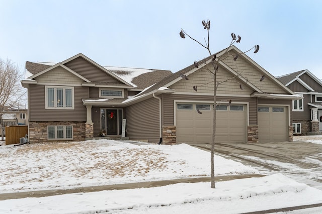 view of front of property with a garage and central AC