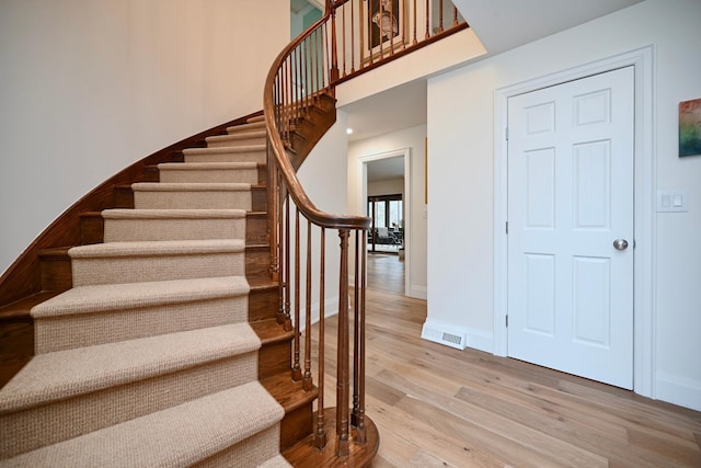 stairway featuring wood-type flooring