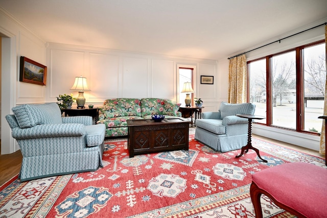 living room featuring ornamental molding and wood-type flooring