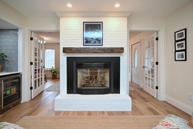 room details featuring wine cooler, wood-type flooring, and a fireplace