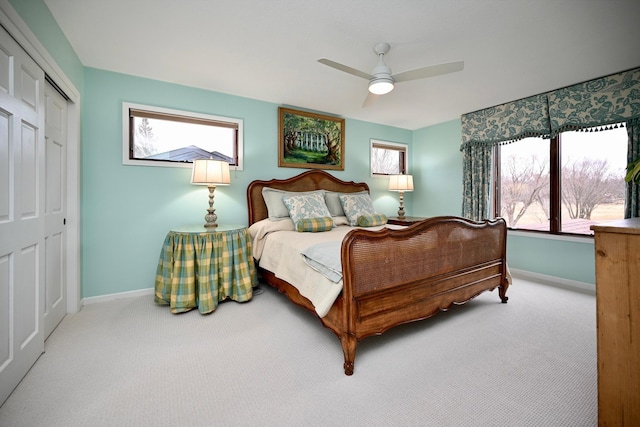 carpeted bedroom featuring ceiling fan and a closet