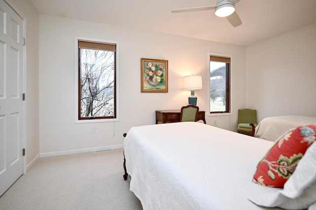 bedroom with ceiling fan and light colored carpet