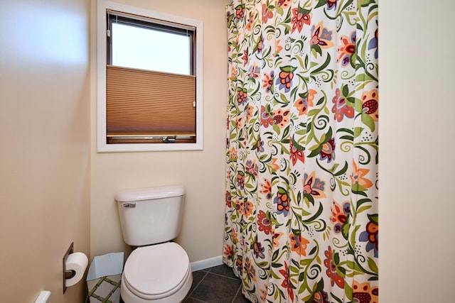 bathroom featuring toilet and tile patterned flooring