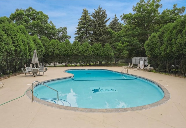 pool featuring a patio area and fence