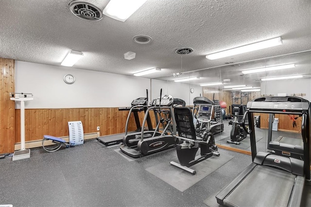 gym with visible vents and a textured ceiling