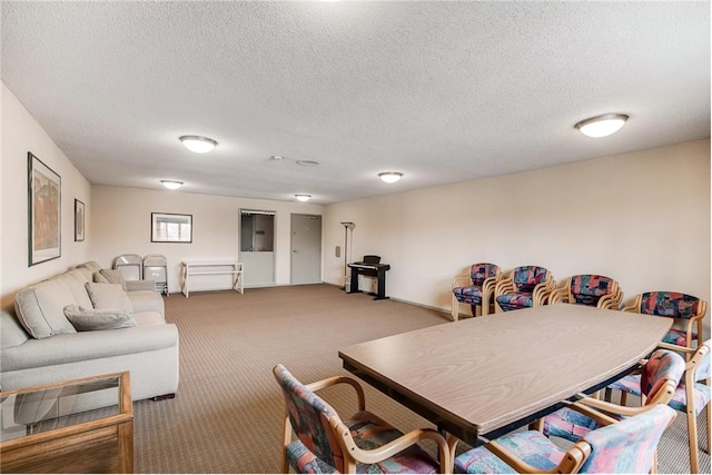 dining space with a textured ceiling and carpet flooring