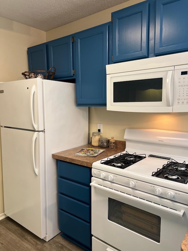 kitchen featuring blue cabinets, white appliances, a textured ceiling, and dark wood-type flooring