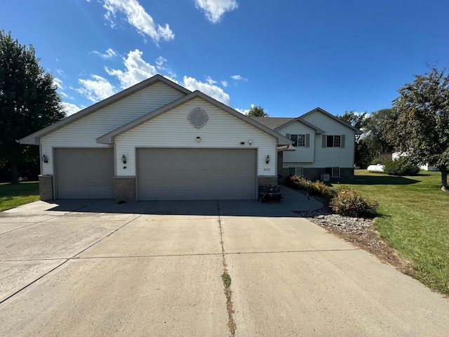 view of front of home with a garage and a front lawn