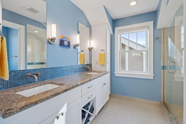 full bath featuring a shower stall, visible vents, decorative backsplash, and a sink