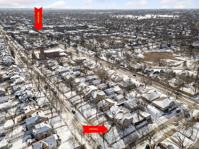 snowy aerial view featuring a residential view