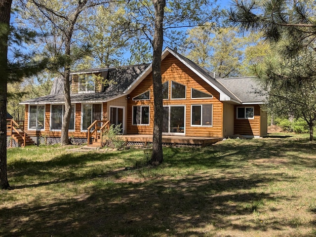 14788 Coyote Dr, Park Rapids, MN 56470 - back of house with a sunroom, a wooden deck, a yard, and roof with shingles