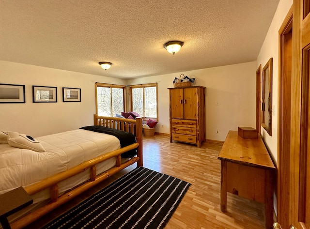 14788 Coyote Dr, Park Rapids, MN 56470 - bedroom with light wood-style floors and a textured ceiling