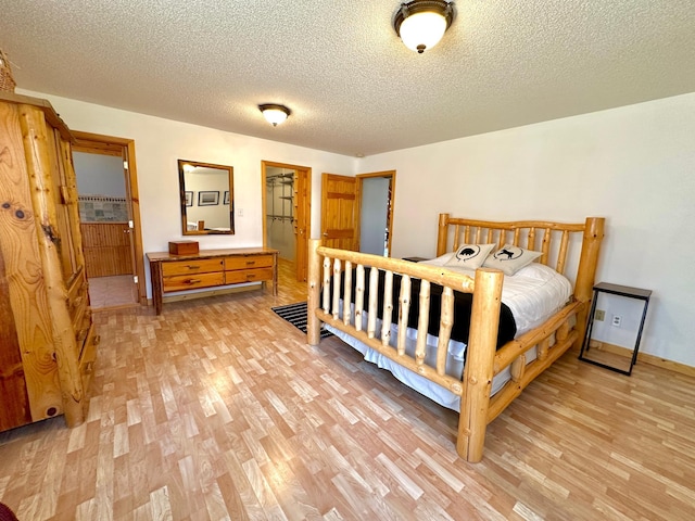 14788 Coyote Dr, Park Rapids, MN 56470 - bedroom with light wood-style floors and a textured ceiling