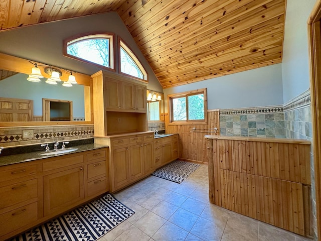 14788 Coyote Dr, Park Rapids, MN 56470 - full bathroom with vaulted ceiling, wainscoting, wood ceiling, tile patterned floors, and vanity
