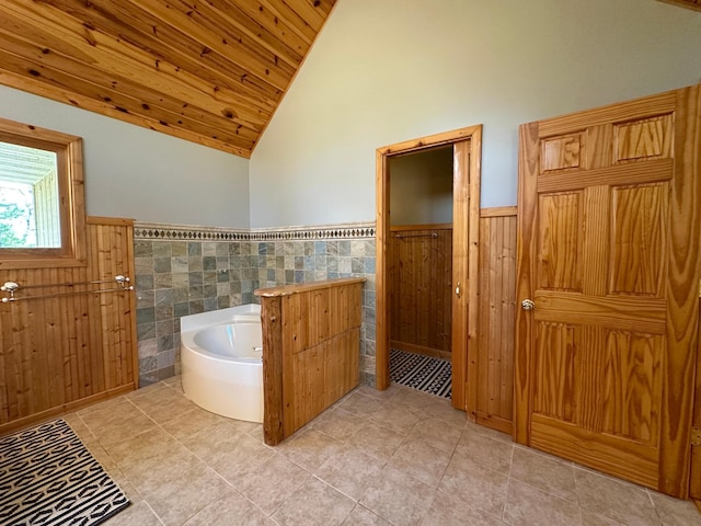 14788 Coyote Dr, Park Rapids, MN 56470 - full bath featuring a wainscoted wall, lofted ceiling, a garden tub, wooden ceiling, and tile patterned floors