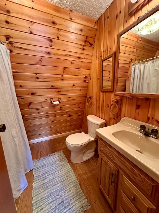 14788 Coyote Dr, Park Rapids, MN 56470 - bathroom with vanity, wooden walls, wood finished floors, and curtained shower