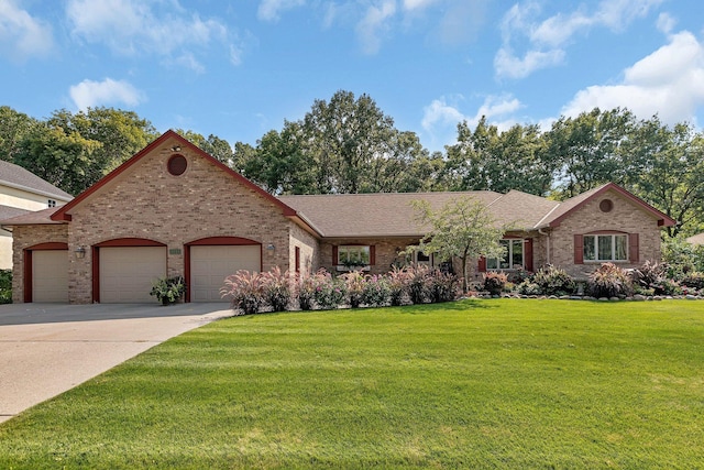ranch-style home with a front lawn, roof with shingles, driveway, brick siding, and a garage