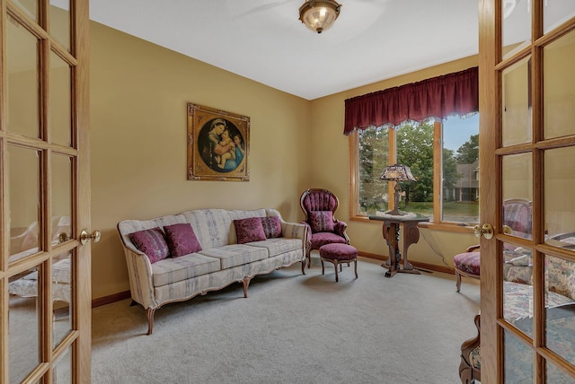 sitting room featuring carpet flooring, baseboards, and french doors