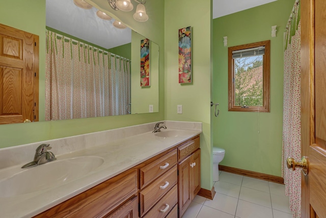 full bath with tile patterned flooring, double vanity, toilet, and a sink