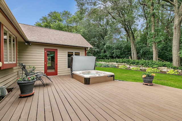 wooden terrace featuring a lawn and a hot tub